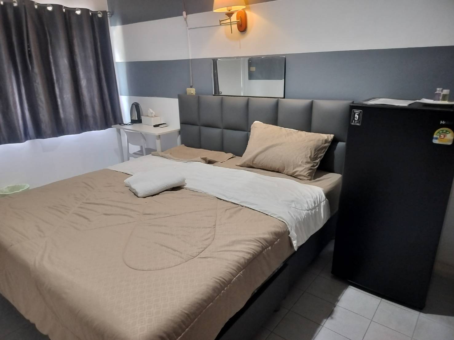Double bed and refrigerator in guest room